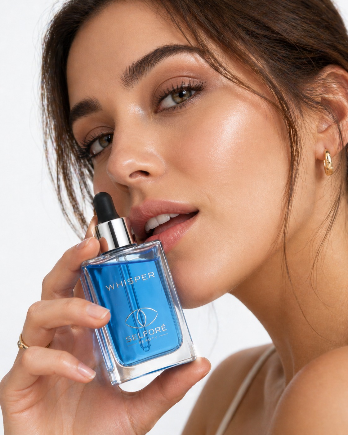 Selfore Whisper peptide serum held close to the face in soft focus